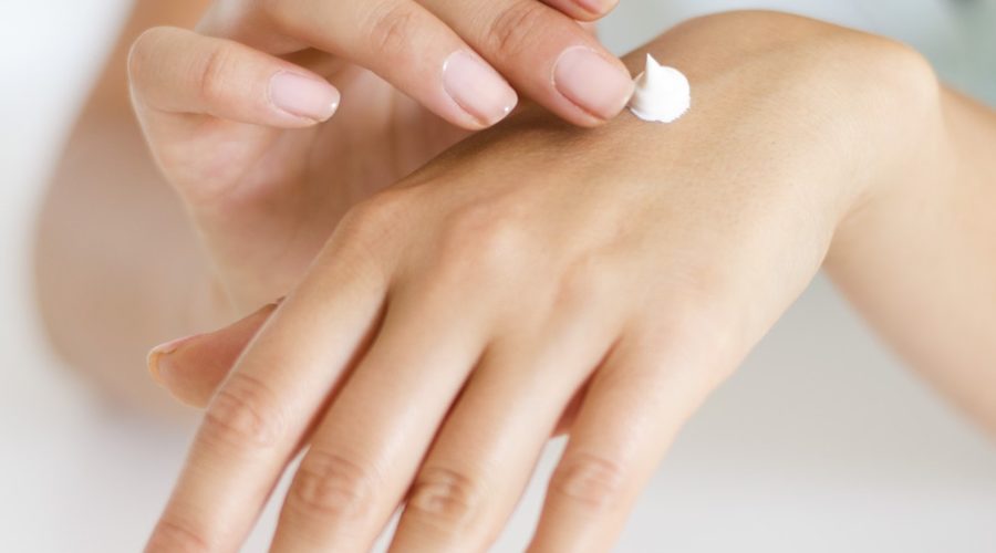 Woman with a dab of hand cream - best skin: ingredients to avoid