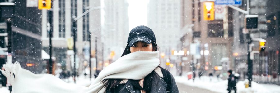 Woman in the middle of a winter city street - Winter skin tips