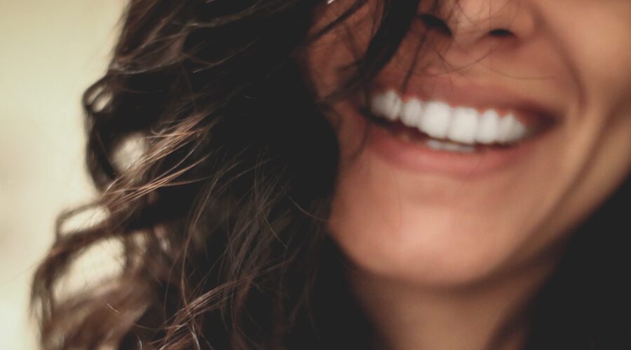 Woman's blurred face with smile - emotions and skin