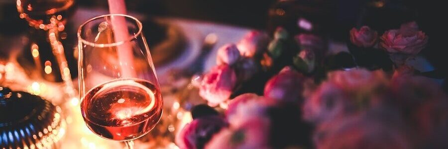 Candlelight table with wine glass - alcoholic beverages and skin