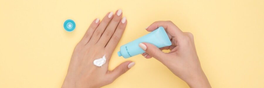 Woman putting on hand cream - safe skin ingredients