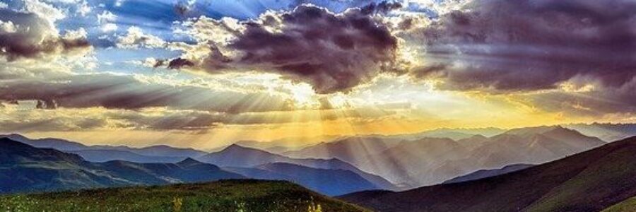Sun shining through clouds over mountain range - herbal medicine for acne