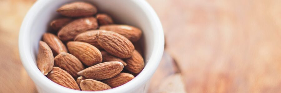 shelled almonds in a small white bowl