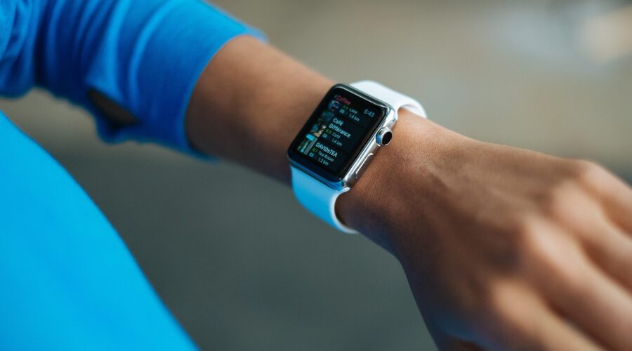 a forearm with a wristwatch that is also digital health monitor device